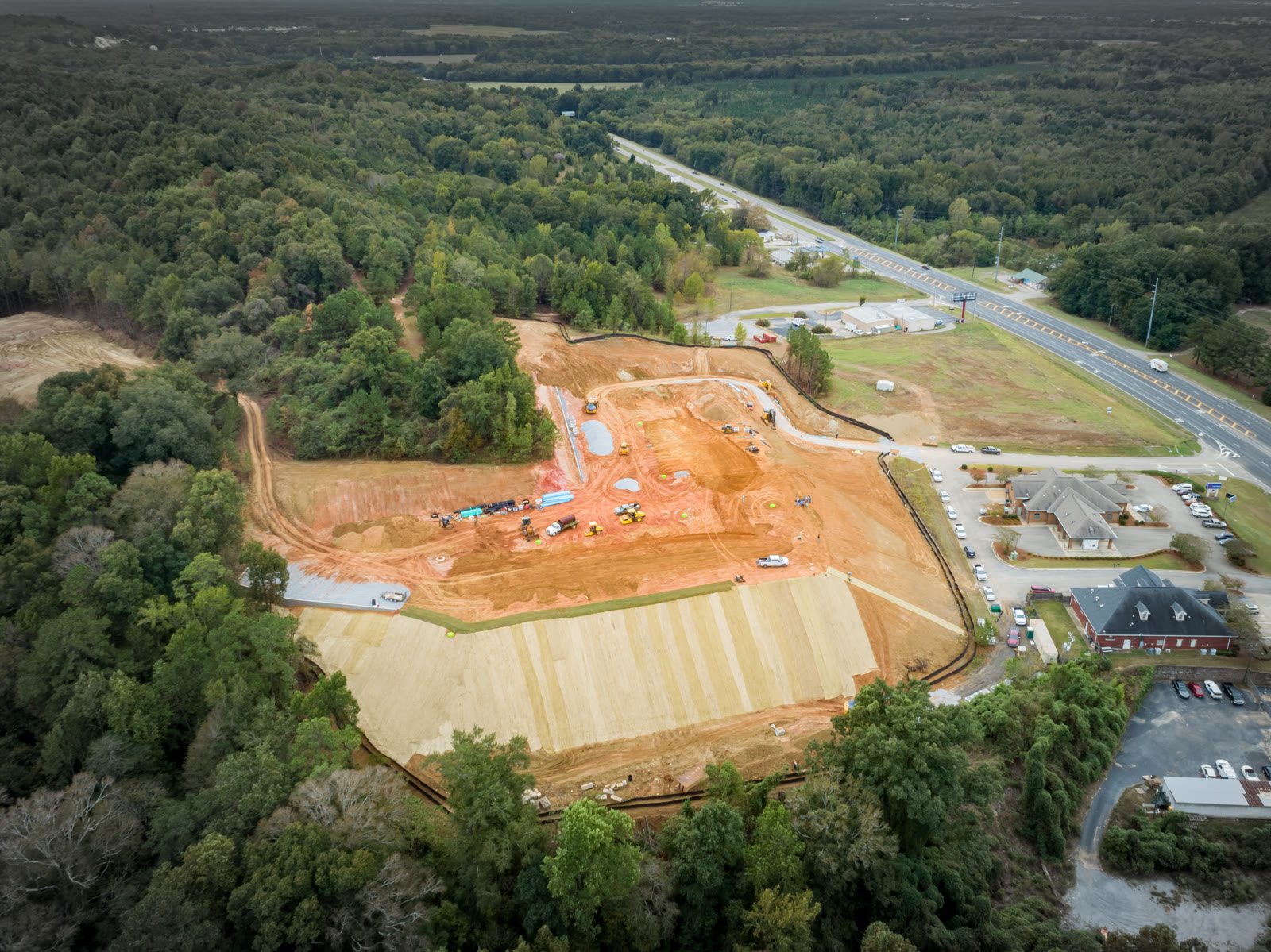 Nathan's Ridge — aerial view of mass-graded site near major highway
